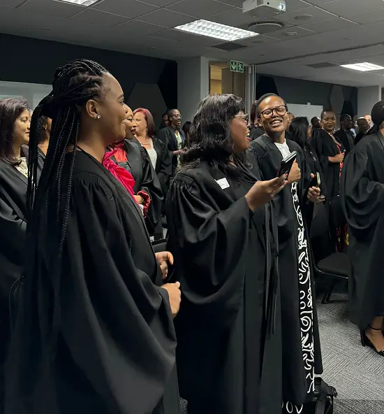 Students standing at a graduation ceremony.
