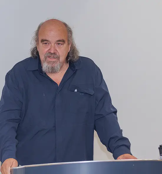 Anton standing at a podium giving a speech.